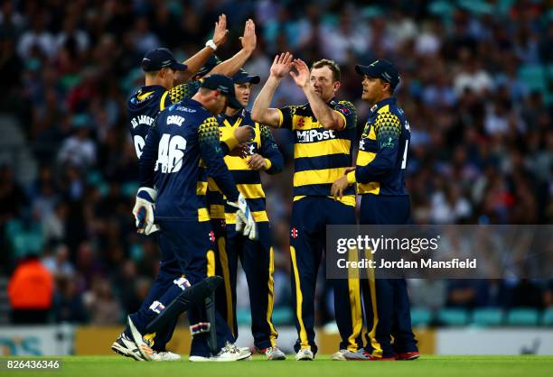 Graham Wagg of Glamorgan celebrates with his teammates after dismissing Mark Stoneman of Surrey during the NatWest T20 Blast match between Surrey and...