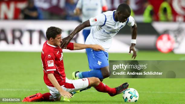 Wilson Kamavuaka of Darmstadt challenges Benjamin Kessel of Kaiserslautern during the Second Bundesliga match between 1. FC Kaiserslautern and SV...
