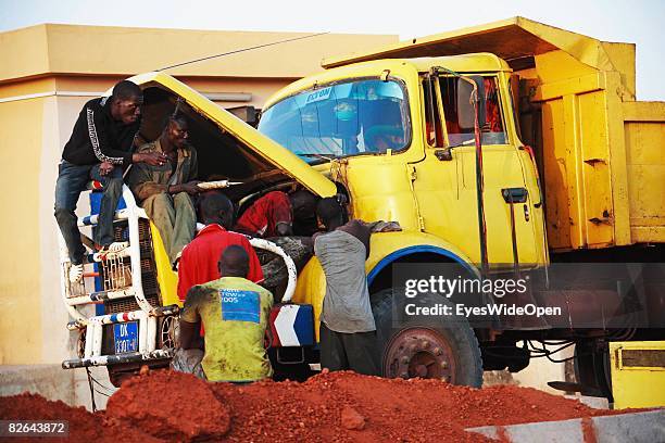 Several mechanics try to repair an truck on December 27, 2007 in Dakar, Republic of Senegal. Dakar is the capital city of Senegal that is bounded by...