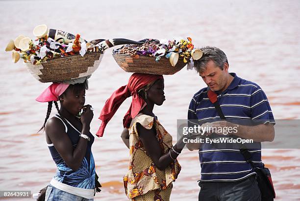 Local women try to sell souvenirs to a tourist at the very salty Retba-Lake where locals extract salt on December 27, 2007 near Dakar, Republic of...