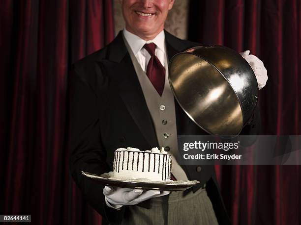 butler serving dessert on silver serving tray. - domed tray stock pictures, royalty-free photos & images