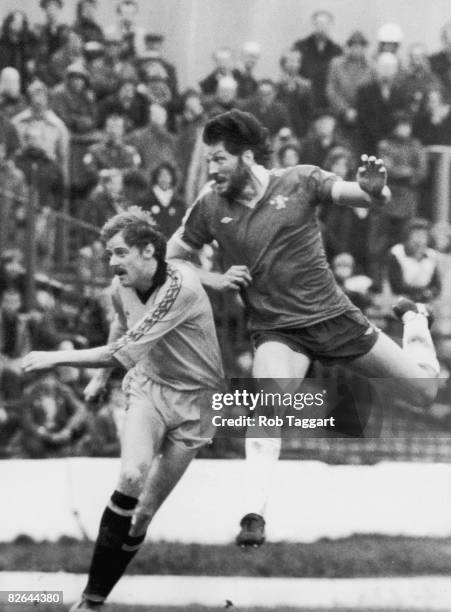 Micky Droy of Chelsea heads the ball over George Reilly of Cambridge United during a match at Stamford Bridge, London, 7th February 1981.