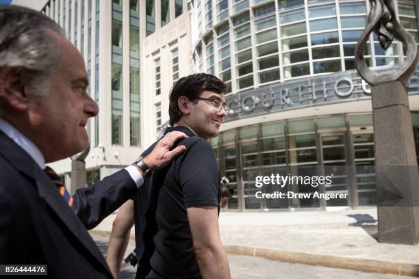 Lead defense attorney Benjamin Brafman walks with former pharmaceutical executive Martin Shkreli after the jury issued a verdict at the U.S. District...