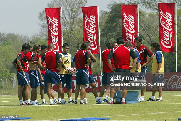 Paraguay's football team players get instructions from coach Gerardo "Tata" Martino during a training session in Ypane, Paraguay, on September 3,...