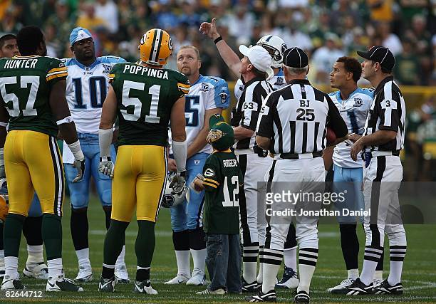 Referee Bill Carollo flips a coin before a game between the Green Bay Packers and the Tenessee Titans on August 28, 2008 at Lambeau Field in Green...