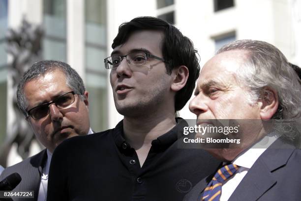 Martin Shkreli, former chief executive officer of Turing Pharmaceuticals AG, center, speaks to members of the media with his attorney Benjamin...