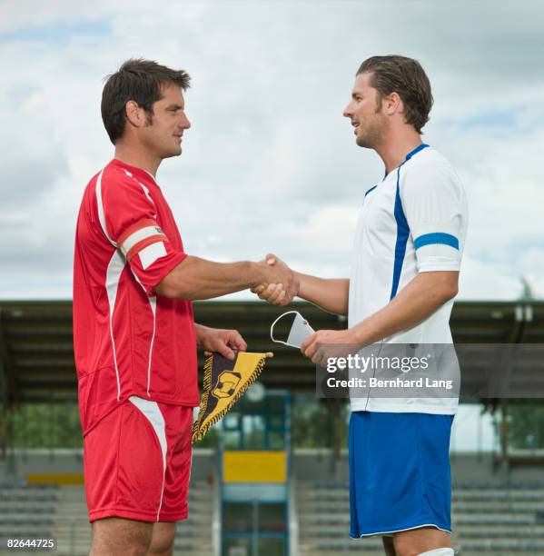 two soccer players shaking hands - moosinning stock pictures, royalty-free photos & images