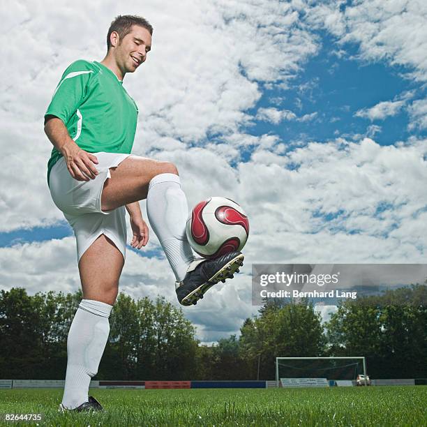 soccer player balancing ball - moosinning stock pictures, royalty-free photos & images