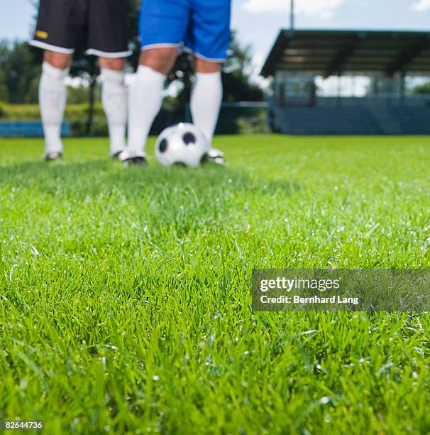 soccer field, two soccer players in background - moosinning stock pictures, royalty-free photos & images