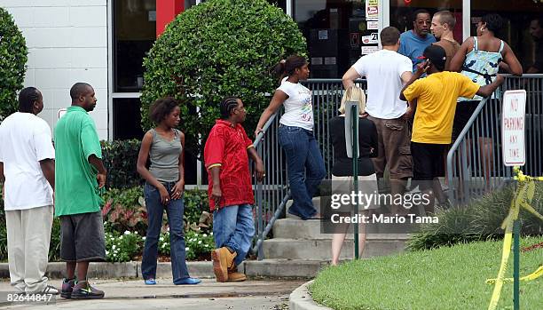 People line up to purchase supplies at a recently re-opened gas station September 3, 2008 in LaPlace, Louisiana. Officials announced that residents...