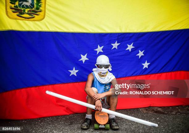 An opposition activist stands by during a protest against the newly inaugurated Constituent Assembly in Caracas on August 4, 2017. - Venezuelan...