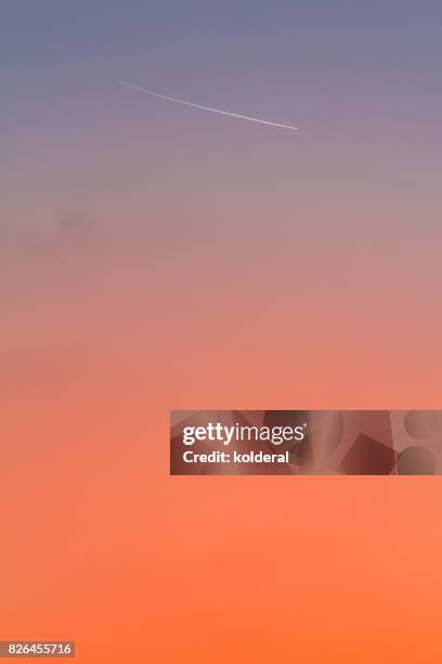 jet trail above mediterranean sea with sunset on background - sunset with jet contrails stock pictures, royalty-free photos & images
