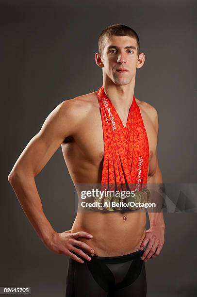 Swimmer Michael Phelps of the United States poses with his eight gold medals all won in competition during the Beijing 2008 Olympic Games on August...