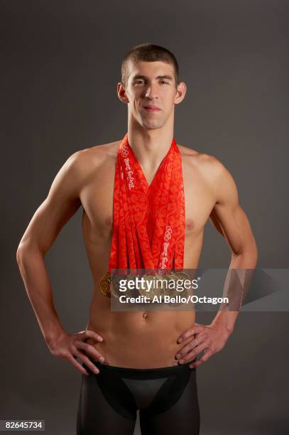 Swimmer Michael Phelps of the United States poses with his eight gold medals all won in competition during the Beijing 2008 Olympic Games on August...