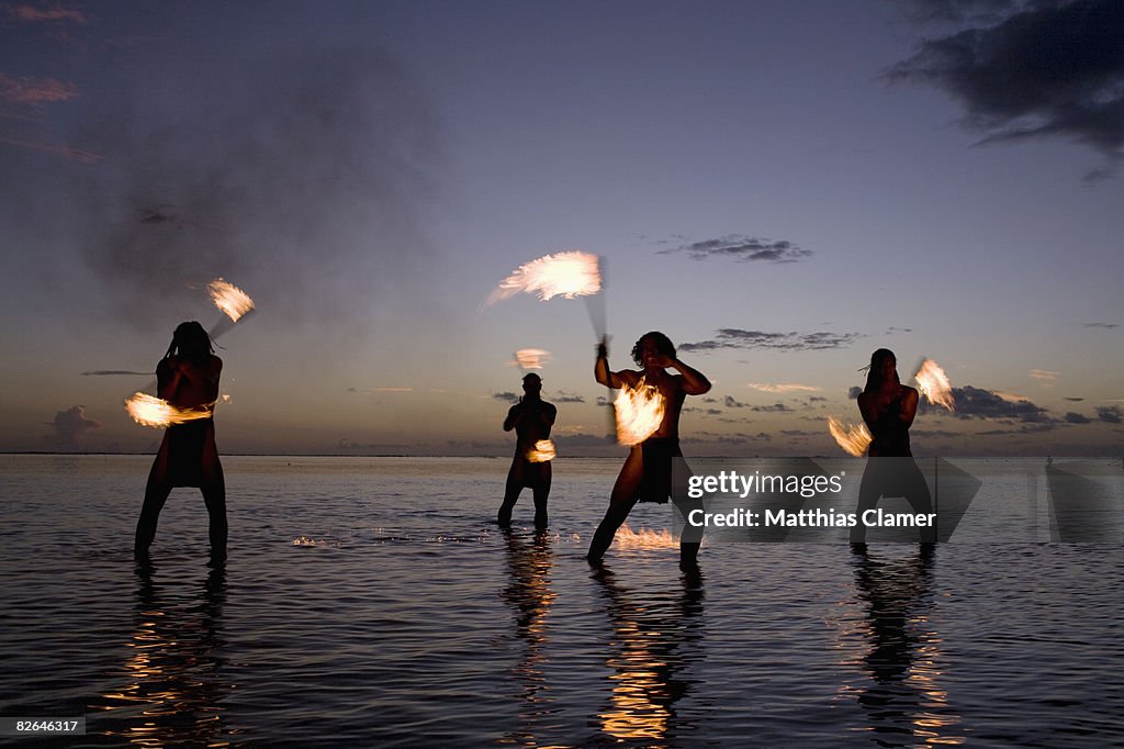 Traditional tahitian fire dancers preforms in fron