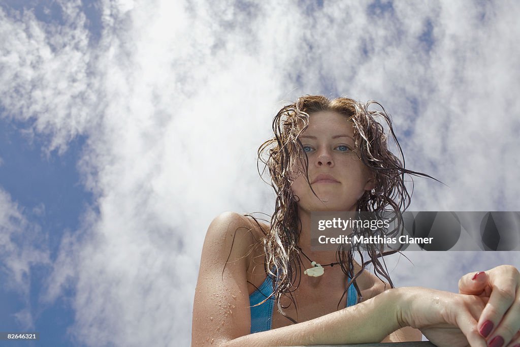 Portrait of young woman with sky behind her