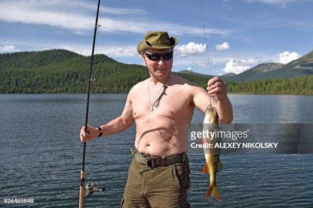 Russian President Vladimir Putin fishes in the remote Tuva region in southern Siberia. The picture taken between August 1 and 3, 2017.