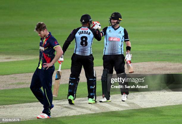 Chris Nash of Sussex Sharks celebrates with teammate Chris Jordan after scoring the winning runs off the bowling of Jimmy Neesham of Kent Spitfires...