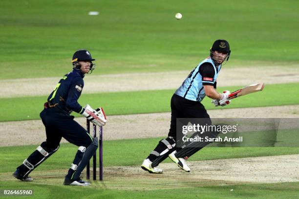 Chris Nash of Sussex Sharks hits out as Kent Spitfires wicket keeper Sam Billings looks on during the match between Kent Spitfires and Sussex Sharks...