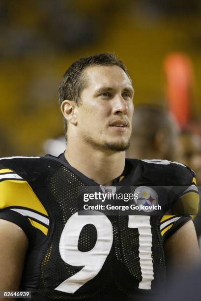 Defensive lineman Aaron Smith of the Pittsburgh Steelers looks on from the sideline during a preseason game against the Carolina Panthers at Heinz...