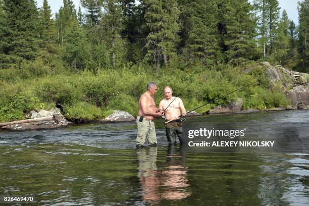 Russian President Vladimir Putin , accompanied by defence minister Sergei Shoigu, fishes in the remote Tuva region in southern Siberia. The picture...