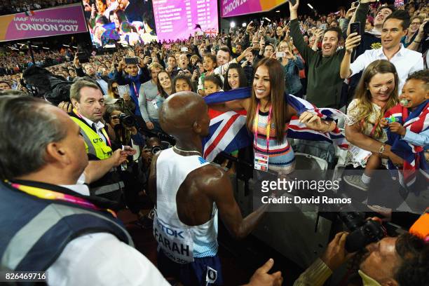 Mo Farah of Great Britain celebrates winning gold in the Men's 10000 metres final with his wife Tania Nell during day one of the 16th IAAF World...