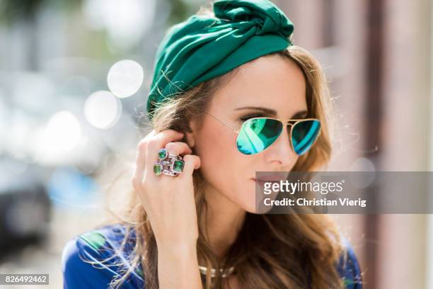 Model and fashion blogger Alexandra Lapp wearing a blue Kimono maxi dress with green leaf print from Borgo de Nor, green metallic Aviator sunglasses...