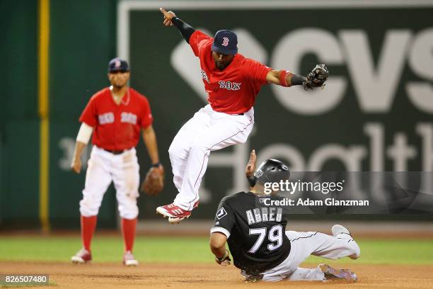 Jose Abreu of the Chicago White Sox is out at second base as Eduardo Nunez of the Boston Red Sox jumps over his slide in the eighth inning of a game...