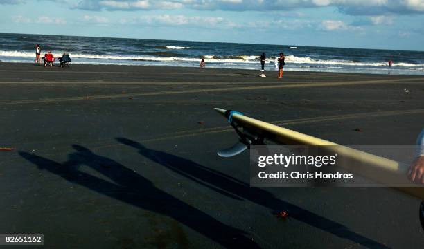 Surfers and swimmers stand on the beach September 3, 2008 in Tybee Island, Georgia. Hurricane Hanna poses a potential threat to the tiny resort...