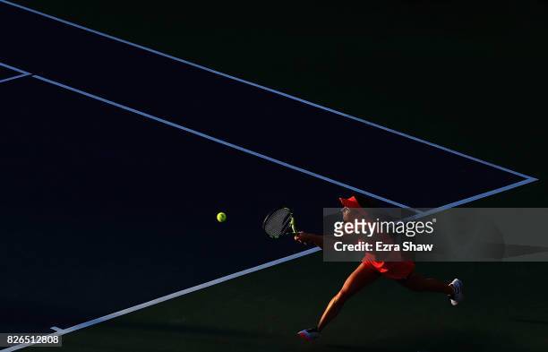 Catherine Bellis of the United States returns a shot to Petra Kvitova of the Czech Republic during their quarterfinal match on Day 5 of the Bank of...