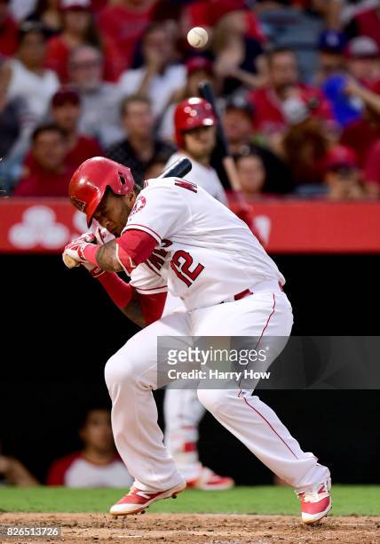 Martin Maldonado of the Los Angeles Angels reacts as he is hit on the helmet by a pitch during the second inning against the Oakland Athletics at...