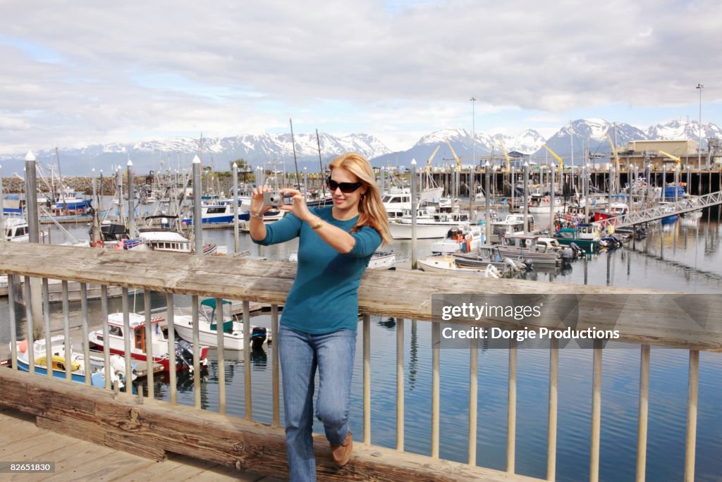 Woman taking a snapshot in Homer Alaska