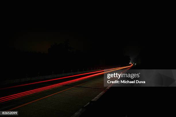 highway at night with car light blur - light trails stock-fotos und bilder