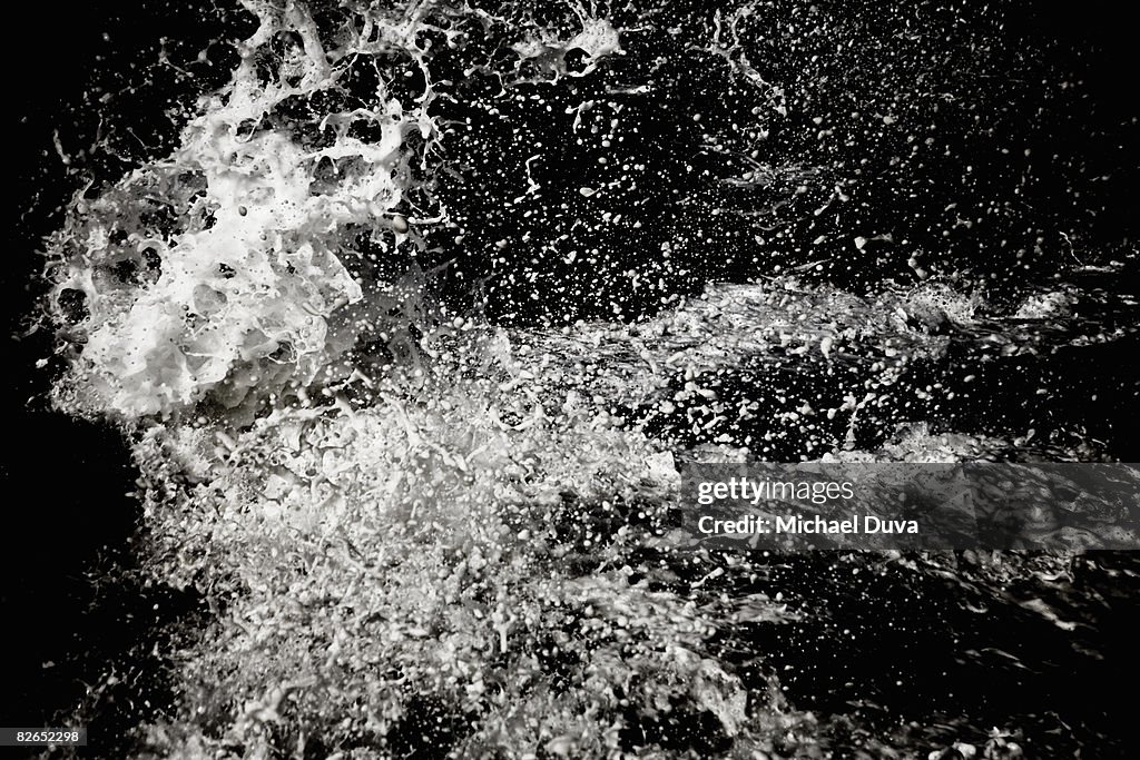 Water splashing on black background