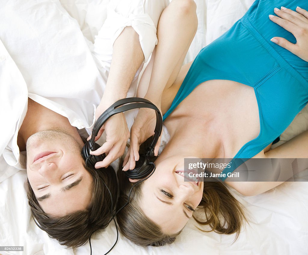 Couple listening to music together with headphones