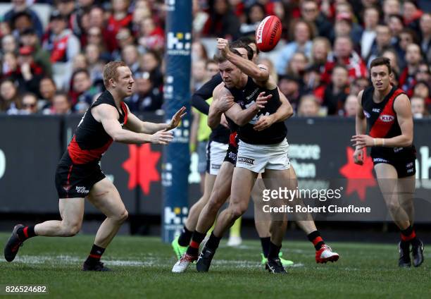 Sam Docherty of the Blues handballs during the round 20 AFL match between the Essendon Bombers and the Carlton Blues at Melbourne Cricket Ground on...