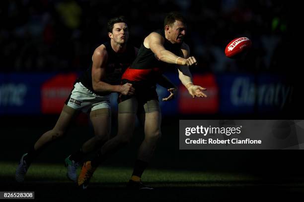 Brendon Goddard of the Bombers handballs during the round 20 AFL match between the Essendon Bombers and the Carlton Blues at Melbourne Cricket Ground...