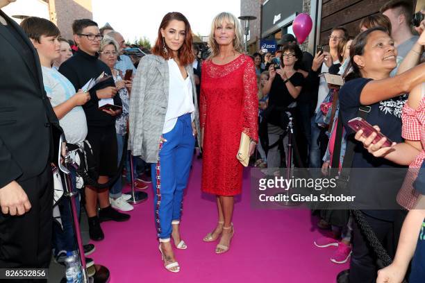 Vanessa Mai and Bo Derek wearing a red dress by Minx during the late night shopping at Designer Outlet Soltau on August 4, 2017 in Soltau, Germany.