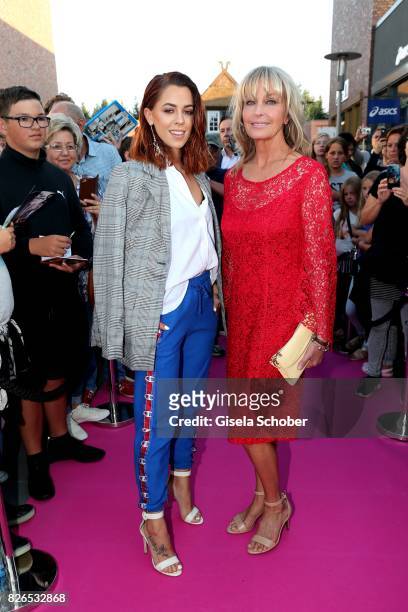 Vanessa Mai and Bo Derek wearing a red dress by Minx during the late night shopping at Designer Outlet Soltau on August 4, 2017 in Soltau, Germany.