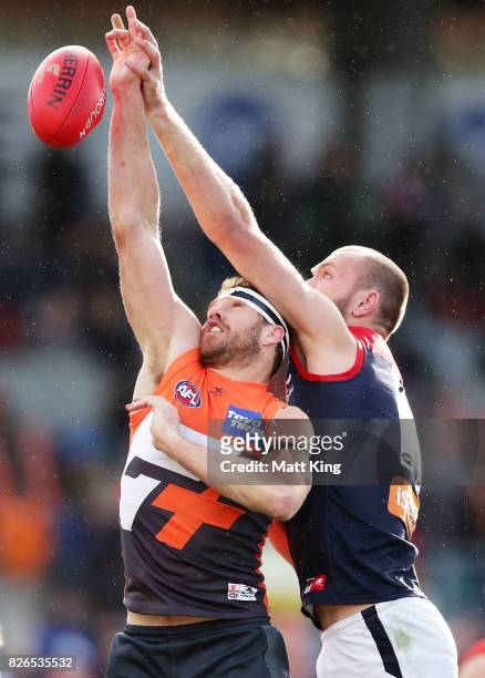 Shane Mumford of the Giants is challenged by Max Gawn of the Demons during the round 20 AFL match between the Greater Western Sydney Giants and the...
