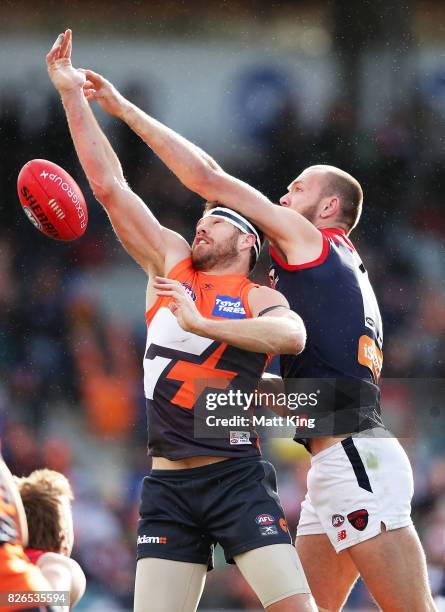 Shane Mumford of the Giants is challenged by Max Gawn of the Demons during the round 20 AFL match between the Greater Western Sydney Giants and the...