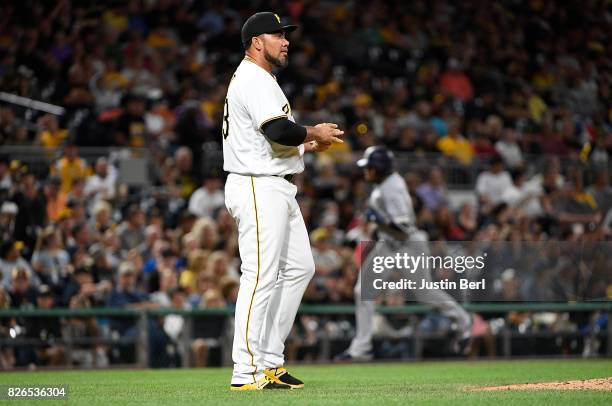 Joaquin Benoit of the Pittsburgh Pirates reacts as Manuel Margot of the San Diego Padres rounds the bases after hitting a solo home run to center...