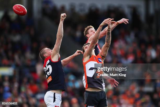 Rory Lobb of the Giants is challenged by Tom McDonald and Oscar McDonald of the Demons during the round 20 AFL match between the Greater Western...