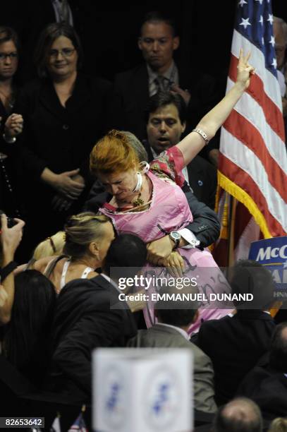 Code Pink supporter is grabbed by security and escorted out during the acceptance speech of Sarah Palin, vice presidential nominee, at the Republican...