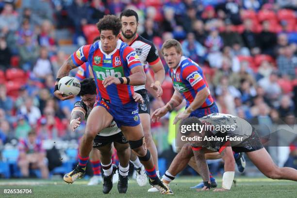 Dane Gagai of the Knights is tackled by the Warriors defence during the round 22 NRL match between the Newcastle Knights and the New Zealand Warriors...