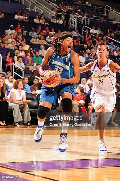 Seimone Augustus of the Minnesota Lynx drives against Kelly Miller of the Phoenix Mercury at U.S. Airways Center September 3, 2008 in Phoenix,...