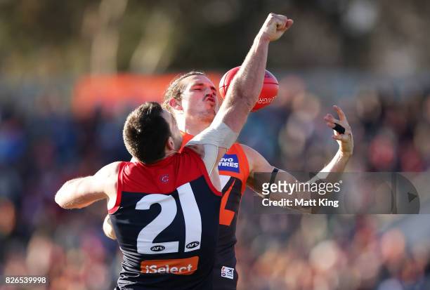 Phil Davis of the Giants is challenged by Cameron Pedersen of the Demons during the round 20 AFL match between the Greater Western Sydney Giants and...