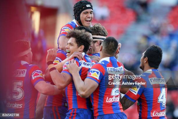 Knights players celebrate a try from Lachlan Fitzgibbon during the round 22 NRL match between the Newcastle Knights and the New Zealand Warriors at...