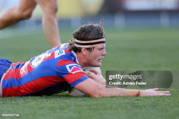 Lachlan Fitzgibbon of the Knights scores a try during the round 22 NRL match between the Newcastle Knights and the New Zealand Warriors at McDonald...