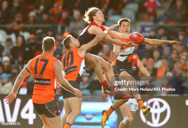 Jayden Hunt of the Demons and Josh Kelly of the Giants contest a mark during the round 20 AFL match between the Greater Western Sydney Giants and the...